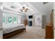This primary bedroom boasts tray ceilings, a ceiling fan, and adjoins the primary bathroom at 32 Pullman Trl, Acworth, GA 30101