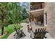 Inviting backyard patio with a stone fire pit, outdoor seating, and manicured landscaping creating a relaxing retreat at 32 Pullman Trl, Acworth, GA 30101