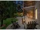 Inviting backyard patio with a stone fire pit, outdoor seating, and landscaped yard at twilight creating a relaxing retreat at 32 Pullman Trl, Acworth, GA 30101