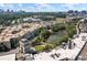 High-angle aerial view offering a glimpse of the property's neighborhood, with a pond and city skyline in the distance at 390 17Th Nw St # 2005, Atlanta, GA 30363