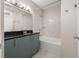 Bathroom with tub, shower, vanity, and neutral tile accents at 390 17Th Nw St # 2005, Atlanta, GA 30363