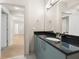 Modern bathroom with granite countertop, stylish vanity, and adjacent rooms with hardwood flooring at 390 17Th Nw St # 2005, Atlanta, GA 30363