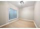An empty bedroom with hardwood floors, a unique glass block window, and neutral paint at 390 17Th Nw St # 2005, Atlanta, GA 30363