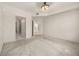 An empty bedroom with carpet floors, an industrial ceiling fan, and neutral paint at 390 17Th Nw St # 2005, Atlanta, GA 30363