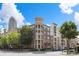 Beautiful low-rise condominium with brick and stucco exterior plus mature trees on a sunny day at 390 17Th Nw St # 2005, Atlanta, GA 30363