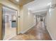 Inviting hallway with tiled floors and modern sconces, leading to the living area of unit 2005 at 390 17Th Nw St # 2005, Atlanta, GA 30363