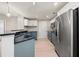 Modern kitchen features stainless steel appliances, blue cabinets, and granite countertops at 390 17Th Nw St # 2005, Atlanta, GA 30363