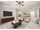 Well-lit living room featuring a ceiling fan, and an open floor plan leading into the kitchen area at 390 17Th Nw St # 2005, Atlanta, GA 30363