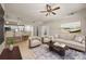 Bright living room featuring modern furnishings, ceiling fan, and an open floor plan leading into the kitchen area at 390 17Th Nw St # 2005, Atlanta, GA 30363