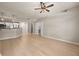 Open-concept living room with hardwood floors, modern ceiling fan, and a view of the kitchen at 390 17Th Nw St # 2005, Atlanta, GA 30363