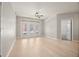Bright and airy living room featuring a modern ceiling fan, fresh paint, and wood floors at 390 17Th Nw St # 2005, Atlanta, GA 30363