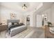 Bedroom with brick accent wall, stylish rug, and ensuite bath and kitchen access at 390 17Th Nw St # 2005, Atlanta, GA 30363