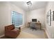 Bright office space featuring a glass block window, desk, and comfortable armchair, perfect for a home workspace at 390 17Th Nw St # 2005, Atlanta, GA 30363