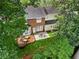 Aerial view of backyard with deck, patio, lush lawn, and mature trees providing ample shade at 1117 Haven Glen Ne Ln, Brookhaven, GA 30319