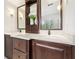 Bathroom with dual dark wood vanity, white countertops and framed mirrors in a well lit space at 1117 Haven Glen Ne Ln, Brookhaven, GA 30319