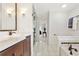 Elegant bathroom with a soaking tub, wood vanity, walk in closet and tiled floors at 1117 Haven Glen Ne Ln, Brookhaven, GA 30319