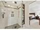Modern tiled shower with glass enclosure, shelving and open access to the main bedroom at 1117 Haven Glen Ne Ln, Brookhaven, GA 30319