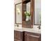 Bathroom features a wooden vanity, marble countertop, dual sinks, and a decorative cabinet at 1117 Haven Glen Ne Ln, Brookhaven, GA 30319
