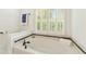 A soaking tub with white shutters that allow lots of natural light to come into the bathroom at 1117 Haven Glen Ne Ln, Brookhaven, GA 30319