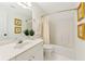 Traditional bathroom with white vanity, large mirror, shower-tub combo, and art on the walls at 1117 Haven Glen Ne Ln, Brookhaven, GA 30319
