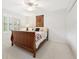 Bedroom with beautiful wood sleigh bed, white walls, and closet with mirrored doors at 1117 Haven Glen Ne Ln, Brookhaven, GA 30319
