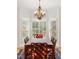 Formal dining room featuring an elegant chandelier, large windows, and a table with seating for eight at 1117 Haven Glen Ne Ln, Brookhaven, GA 30319