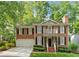 Charming brick home featuring black shutters, lush landscaping and an attached two car garage at 1117 Haven Glen Ne Ln, Brookhaven, GA 30319