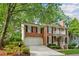 Charming two-story brick home with a manicured lawn, mature trees, and an attached two-car garage at 1117 Haven Glen Ne Ln, Brookhaven, GA 30319