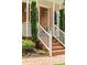 Close up of front porch with brick steps, trimmed bushes and updated white railings at 1117 Haven Glen Ne Ln, Brookhaven, GA 30319