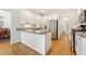 Modern kitchen with stainless steel appliances, granite countertops, white cabinetry and hardwood floors at 1117 Haven Glen Ne Ln, Brookhaven, GA 30319