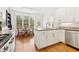 Bright kitchen features stainless appliances, granite countertops, an island, and a breakfast nook at 1117 Haven Glen Ne Ln, Brookhaven, GA 30319