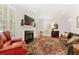 Cozy living room featuring a fireplace, large windows with shutters, and elegant furnishings at 1117 Haven Glen Ne Ln, Brookhaven, GA 30319