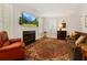 Cozy living room featuring a fireplace, large windows, plantation shutters and a comfortable seating arrangement at 1117 Haven Glen Ne Ln, Brookhaven, GA 30319