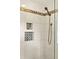 Walk-in shower featuring white tile, mosaic accents, and bronze fixtures at 1117 Haven Glen Ne Ln, Brookhaven, GA 30319