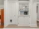 Hallway coffee bar with white cabinets, stylish hardware, and built in shelving at 2054 Palifox Ne Dr, Atlanta, GA 30307