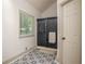 Bathroom featuring a glass shower and patterned tile flooring at 2355 Quail Creek Ter, Buford, GA 30519