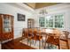 Formal dining room with hardwood floors, decorative china cabinets, and large windows overlooking the yard at 2355 Quail Creek Ter, Buford, GA 30519