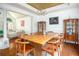 Open-concept dining area featuring hardwood floors, a wooden dining table, and decorative china cabinets at 2355 Quail Creek Ter, Buford, GA 30519
