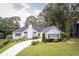 This is a well-maintained white house with verdant front yard and curving driveway at 2355 Quail Creek Ter, Buford, GA 30519