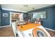 Finished game room with wood floors, dart board and pool table in the next room and a classic car inside at 2355 Quail Creek Ter, Buford, GA 30519