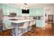 Updated kitchen features an island with seating, stainless steel appliances, and light blue cabinetry at 2355 Quail Creek Ter, Buford, GA 30519