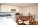 Efficient kitchen with wooden dining set, white appliances and ample storage cabinets at 2355 Quail Creek Ter, Buford, GA 30519