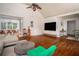 An airy living room is connected to the dining area, featuring shiny hardwood floors at 2355 Quail Creek Ter, Buford, GA 30519