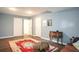 Spacious living room with hardwood floors, oriental rug, and multiple access doors at 2355 Quail Creek Ter, Buford, GA 30519