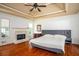 This main bedroom has a marble fireplace, natural light, and hardwood floors at 2355 Quail Creek Ter, Buford, GA 30519