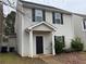 Charming home featuring gray siding, black shutters, and a covered front porch entry at 241 Coral Cir, Mcdonough, GA 30253