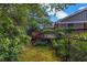 Backyard featuring lush greenery, a wooden deck, and a serene setting for outdoor enjoyment at 2585 Regency E Dr, Tucker, GA 30084