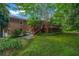 Spacious backyard featuring a wooden deck, mature trees, and a lush green lawn at 2585 Regency E Dr, Tucker, GA 30084