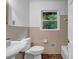 Well-lit bathroom with tiled walls, featuring classic fixtures at 2585 Regency E Dr, Tucker, GA 30084
