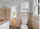 Clean bathroom with tiled walls and floors, featuring classic fixtures and ample natural light at 2585 Regency E Dr, Tucker, GA 30084